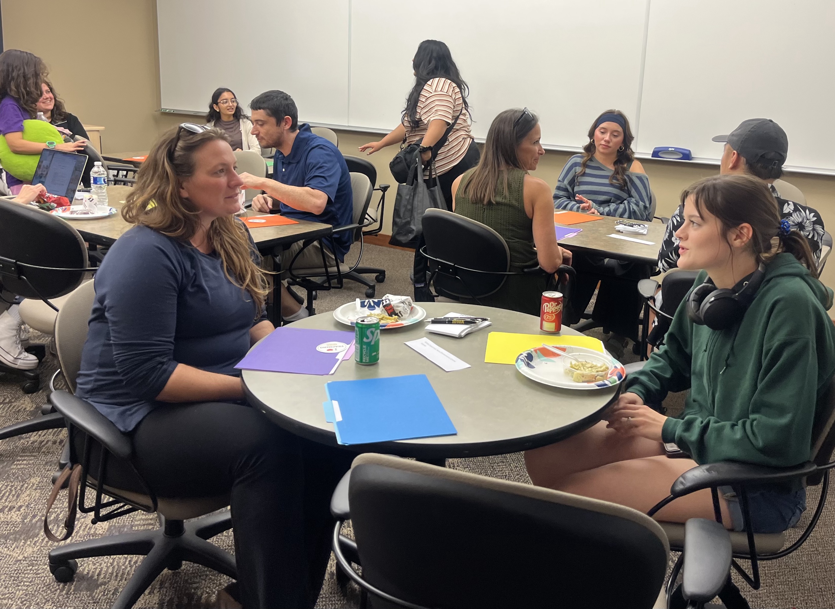 Two attendees chat at a round table during the Fall 2025 Students as Partners kick-off meeting.